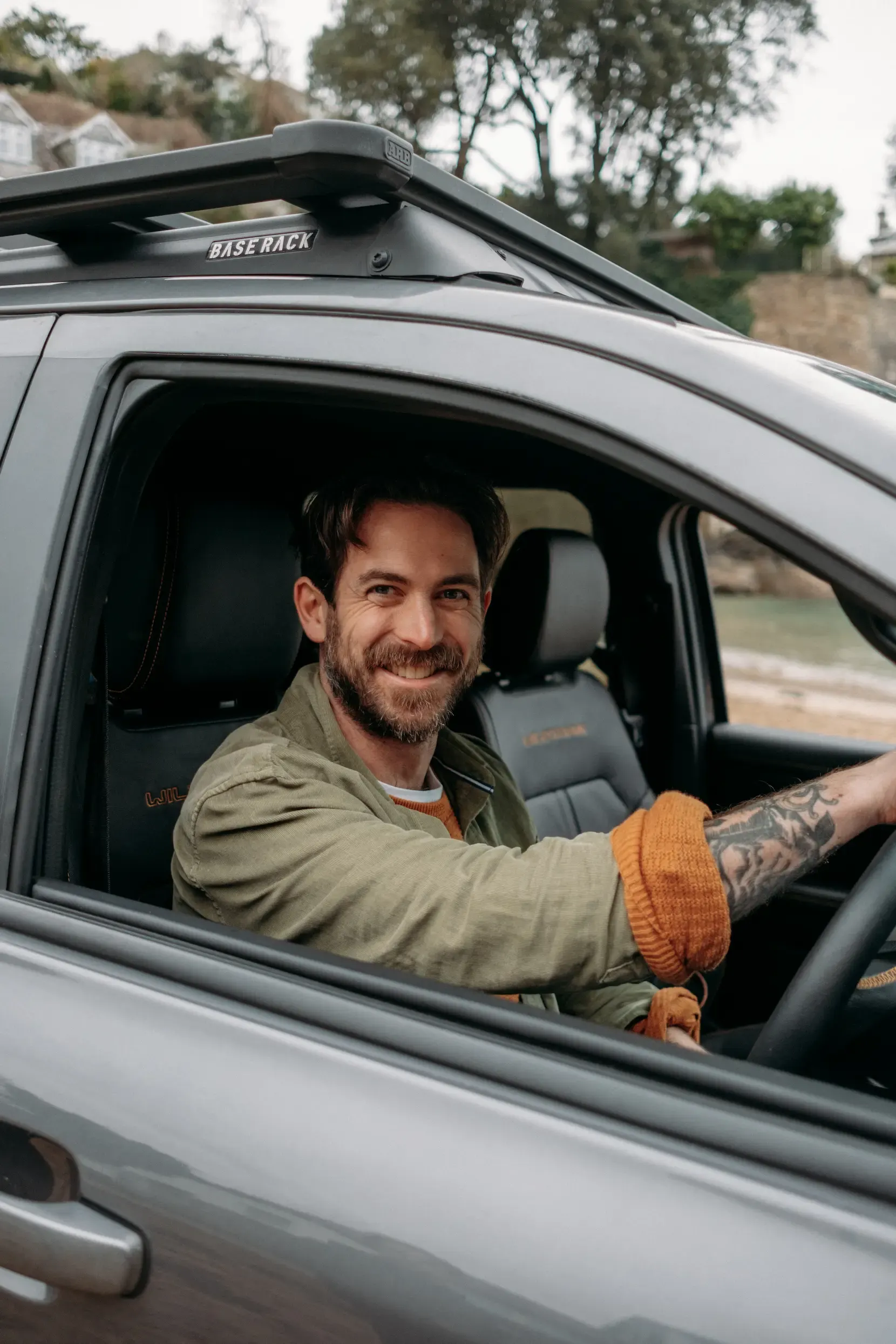 James Strawbridge smiling from the driver’s seat during a vertical social content shoot