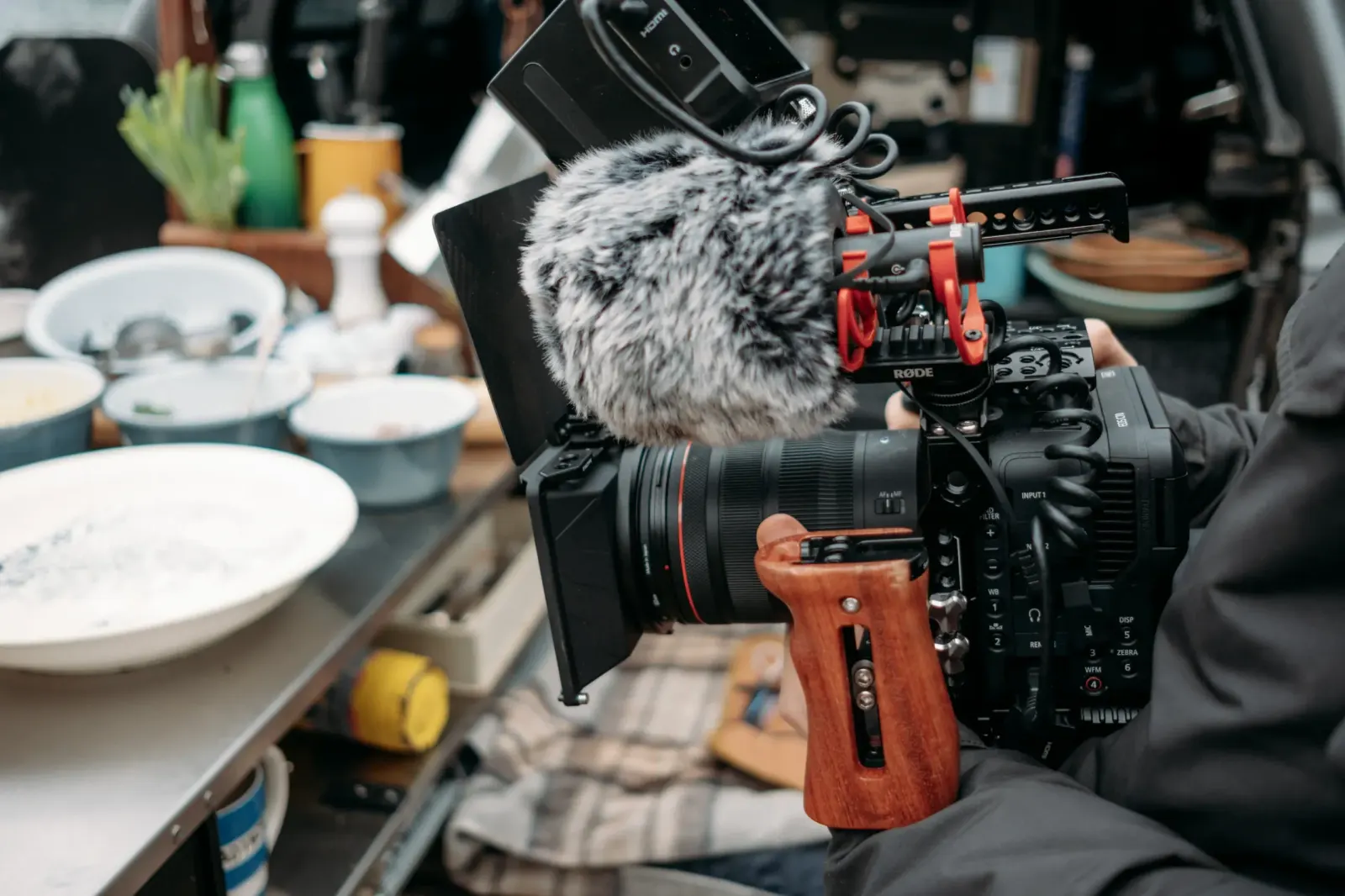 A PixelRain cinema camera filming a cooking setup with ingredients and kitchenware in the background