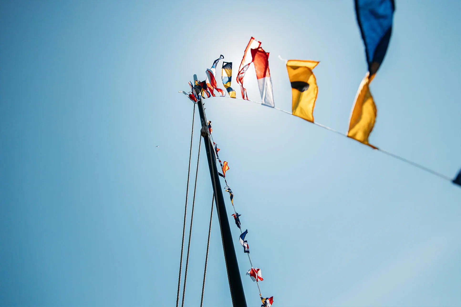 Maritime signal flags flying during filming in Falmouth Harbour.