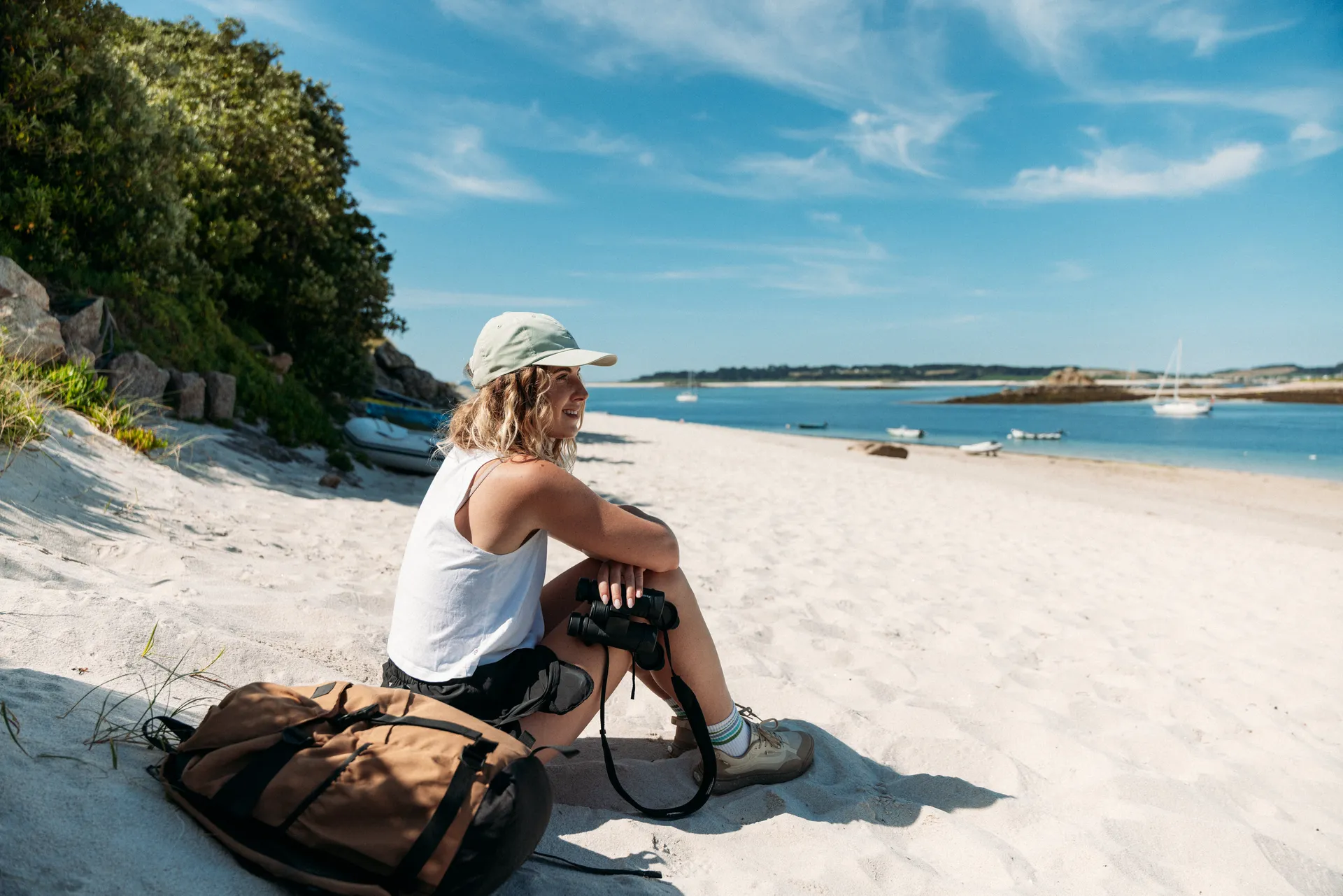 Lydia Cooke sitting on the beach at St Martin's during an Isles of Scilly Travel destination campaign shoot