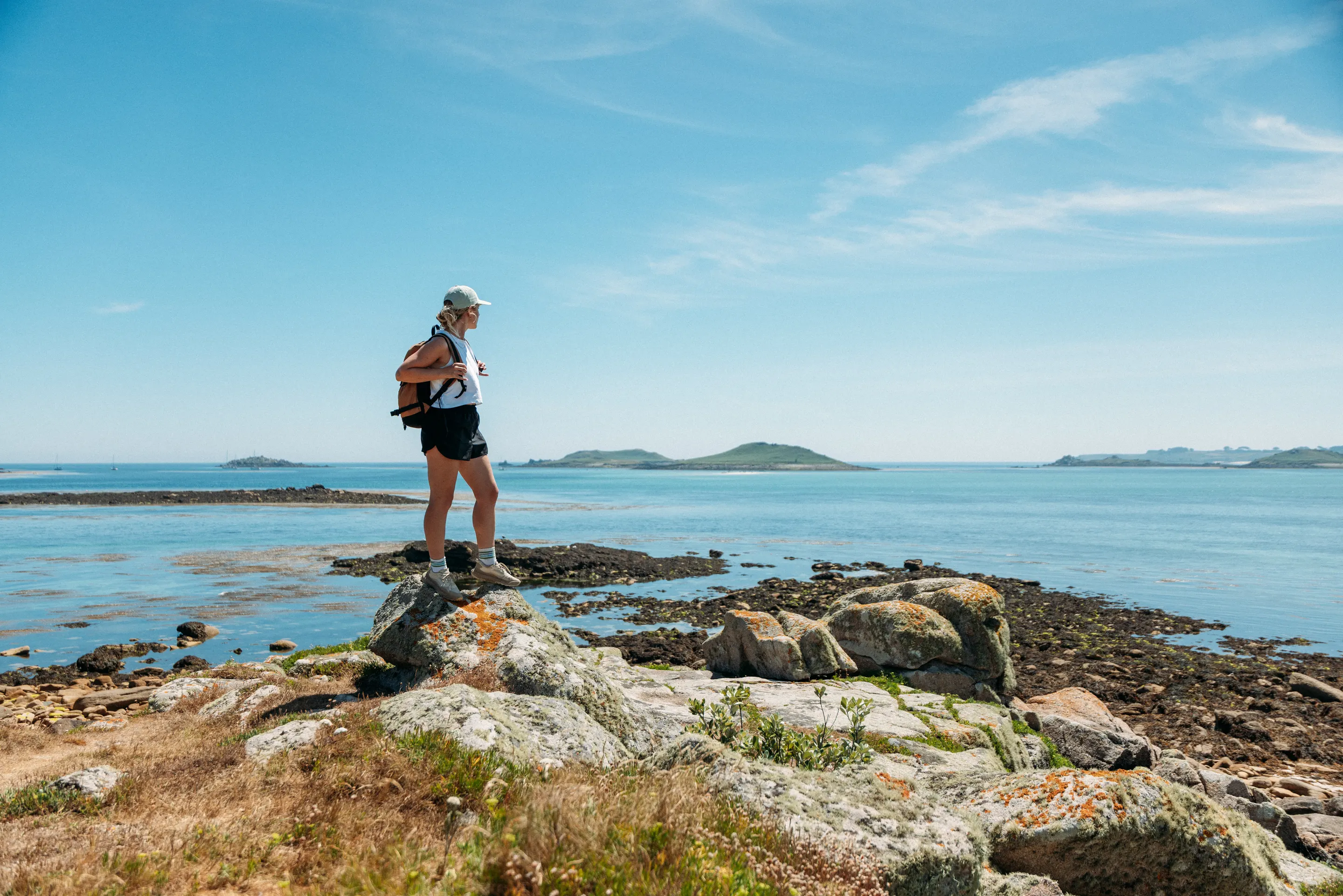 Lydia Cooke overlooking the islands from the rocky shoreline of St Martin's in the Isles of Scilly