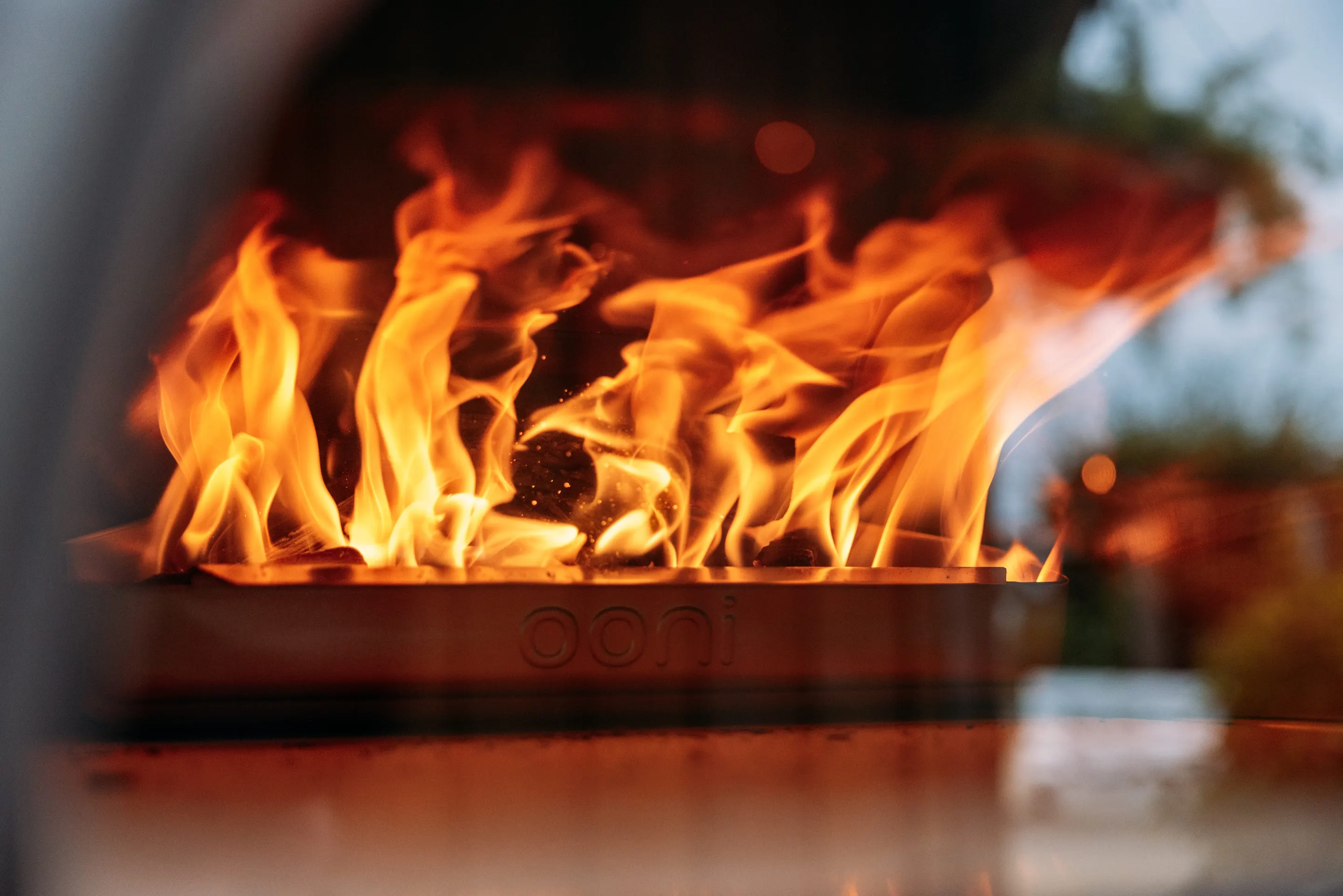 Flames inside an Ooni pizza oven during an Ooni Cooks recipe shoot