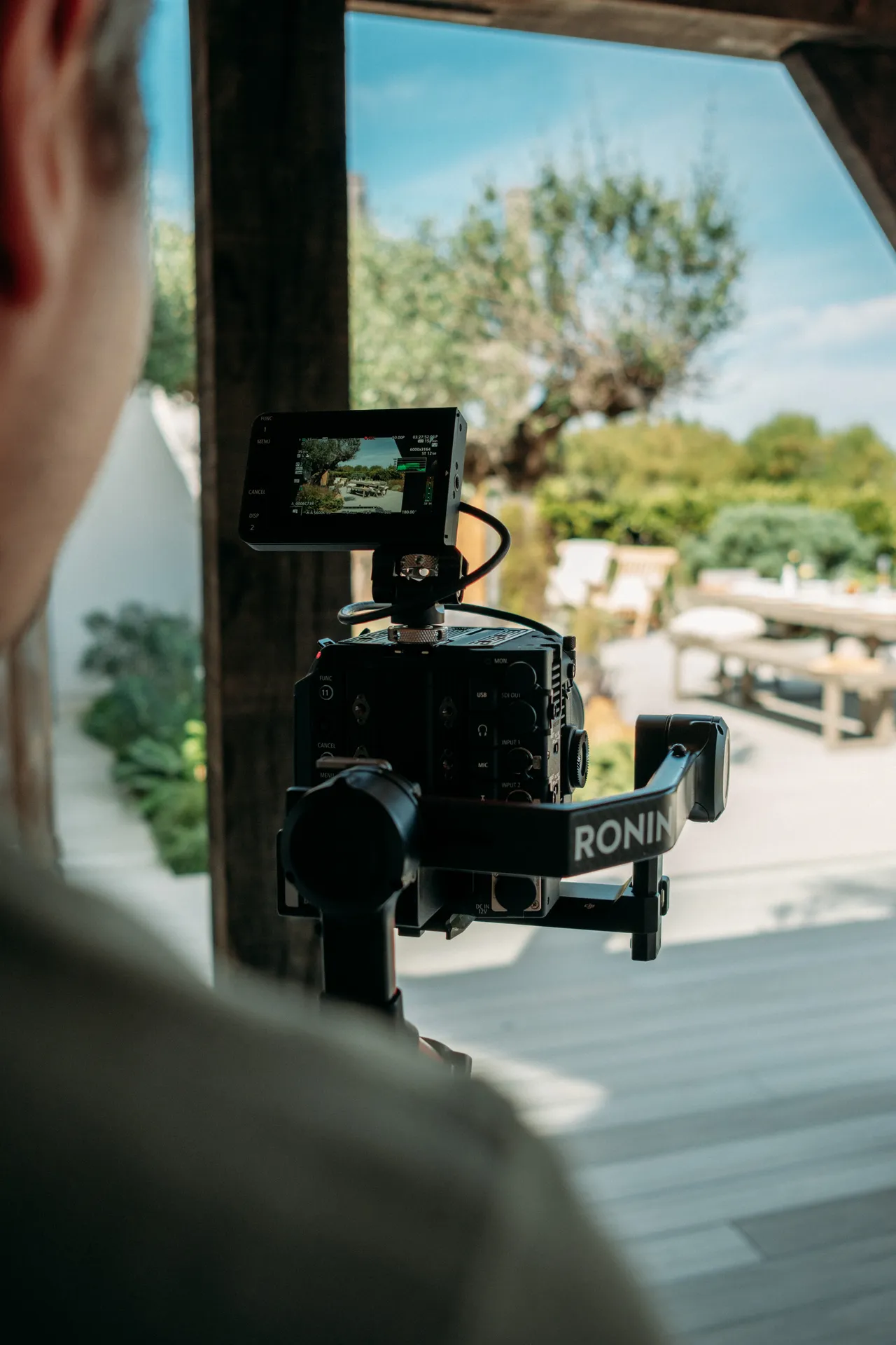 Behind the scenes at Constantia: a camera and gimbal filming through the garden doors